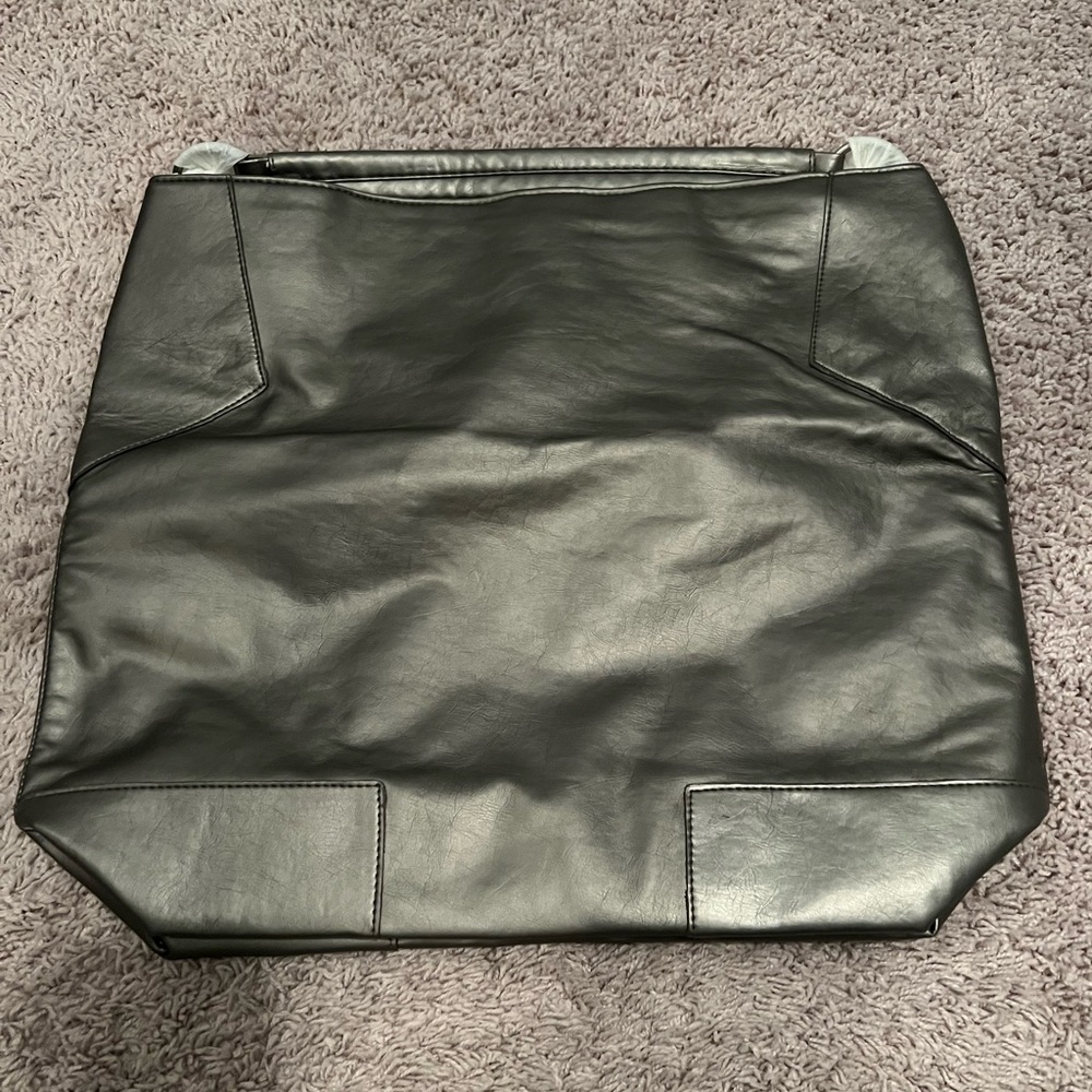 Usher brand handbag in a metallic grayish color.